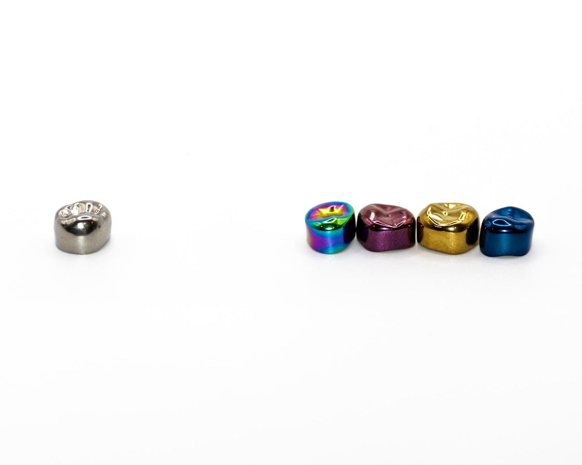 Traditional silver stainless steel crown compared with Prismo colored crowns